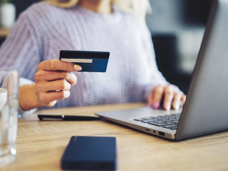 Woman paying by card on the internet flooring products from Touchdown Carpet & Flooring Inc in Marlborough, MA